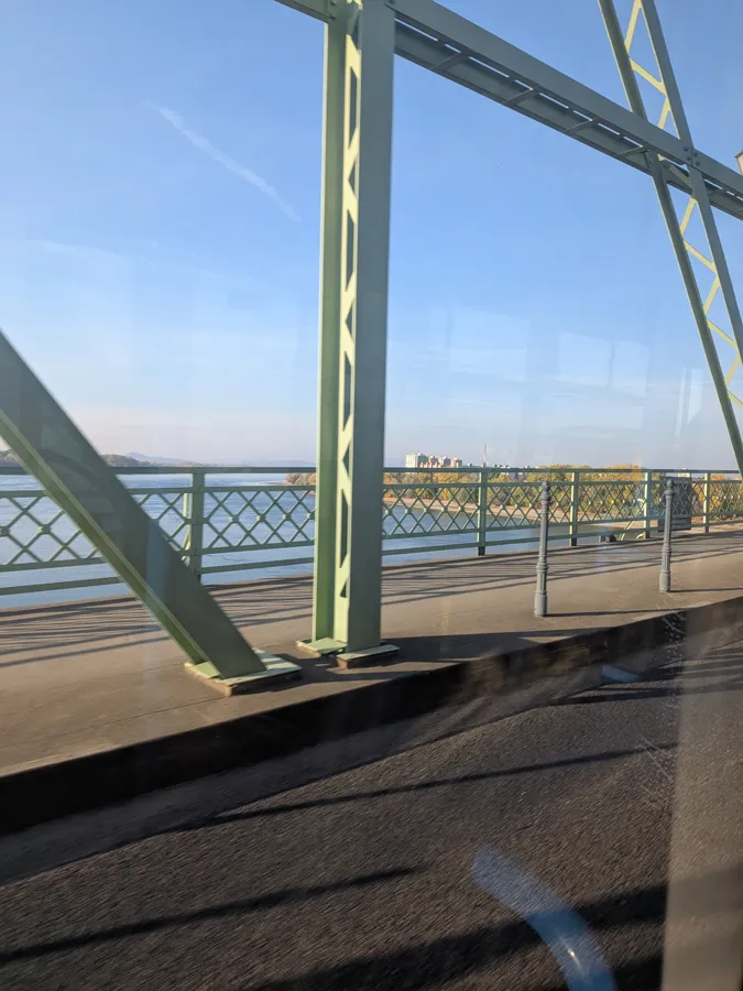 The green steel Mária Valéria Bridge over the Danube, seen from a bus window
